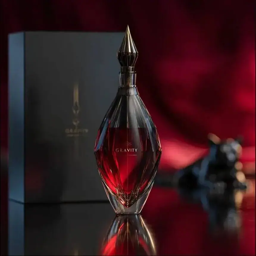 Product launch imagery for a perfume brand: ruby bottle in a lacquered box