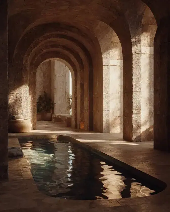 Wellness brand imagery: arched stone pool with still water